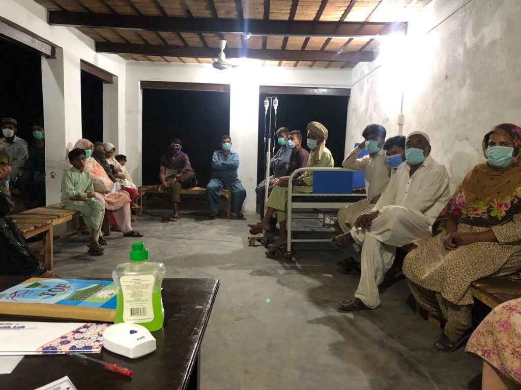 Patients waiting beside a treatment bed at the Free Dispensary