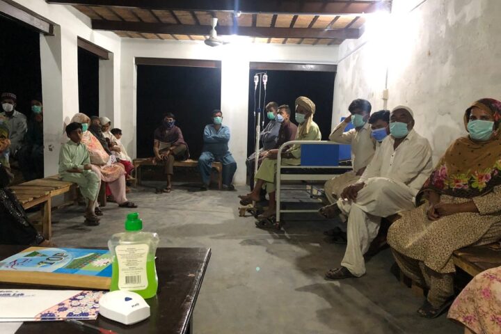 Patients waiting beside a treatment bed at the Free Dispensary